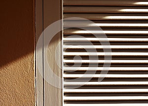 Abstract of line and shadow of sunlight on screen door.