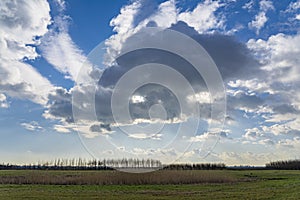 The sun is shielded by the threatening rain clouds over the Bentwoud near Boskoop, the Netherlands