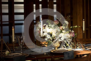 The sun shines on the bouquet on Decoration wedding table.