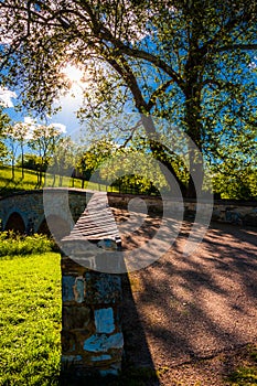 The sun shines through trees over Burnside Bridge, at Antietam National Battlefield