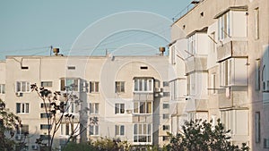 The sun shines on the windows of a big house