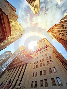 Sun shining above the buildings of Wall Street in Manhattan, New York City