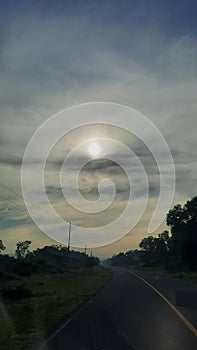 the sun is shining behind the clouds