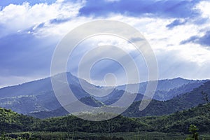 The sun shining through the clouds to the trees on the mountain at Suan phueng of Ratchaburi in Thailand