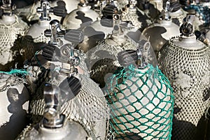 Sun shining onto rows of oxygen tank covered with nets
