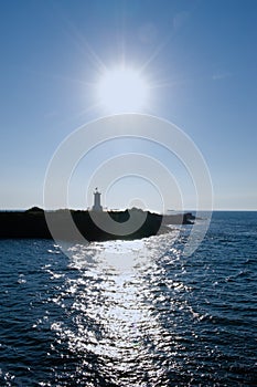 Sun shining over lighthouse