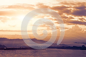 Sun shining over river.