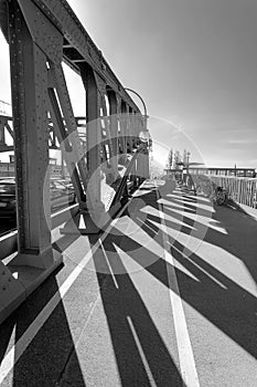 Sun shining through the pillars of a bridge, casting long shadows - Infrared black and white