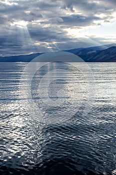 Sun shining through thick cloudy sky, silver lining