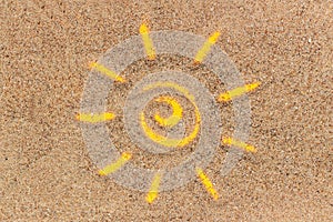 Sun sign drawn on sand and white tube of sunscreen. Template mockup for your design. Creative top view
