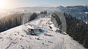 Sun ski resort aerial. Snow mountain top. Nature landscape. Tourist active sport, recreation. People