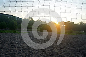 The Sun and the sunlight behind the sport net on the beach. Sunrise in the countryside background. Natural backgrounds.