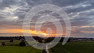 Sun Sunshine In Sunset Bright Sky. Beautiful Evening Sky Above Rural Landscape With Country Road. Young Green Wheat