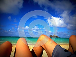 Sun Tanned Legs on a Romantic Beach Tropical Vacation Honeymoon