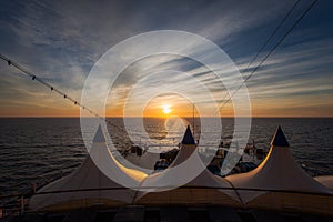 Sun about to set, seen from the stern of a cruise ship