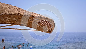 Sun Umbrella on a Beach in Egypt on Red Sea. Sunny Resort on Reef Coast of Sharm el Sheikh
