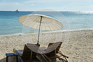 Sun umbrella and chair in beach