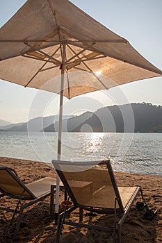 A sun umbrella and lounges on beach