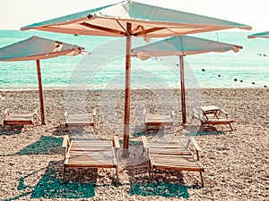 Sun umbrellas and beach beds on the sea coast