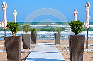 Sun umbrellas and beach chairs on tropical beach,