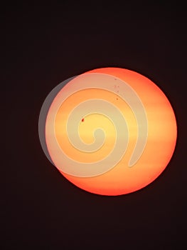 Sun visible through smoke haze showing giant sunspots.