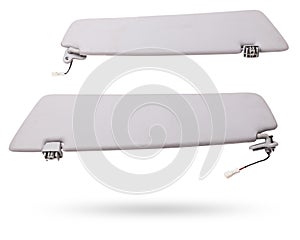 Sun visor with a mirror made of light gray plastic on a white background in a photo studio. Spare part of the car interior for