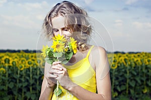 Sun young girl in the field with sunflowers