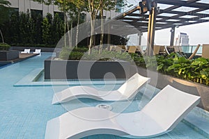 Sunbath chair in the pool ideal for travel and vacation concept