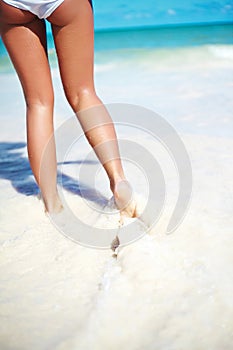 Sunbathed Girl with perfect figure run in summer beach