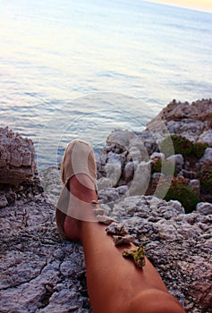 Sunbathed leg decorated with stones