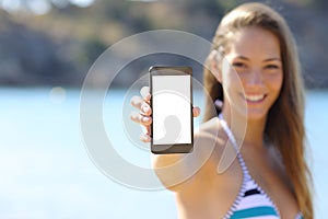 Sunbather showing blank phone screen on the beach photo