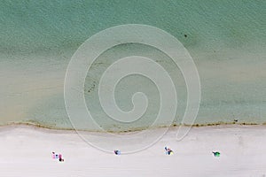 Sunbathers Laying Socially Distanced On Beach Foreshore photo