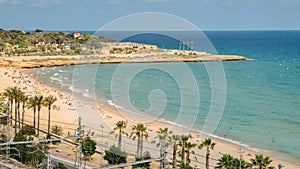 Sunbathers at Miracle Beach in Tarragona, Spain