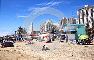 Sunbathers Soaking up Sun on Durban Beach, South Africa