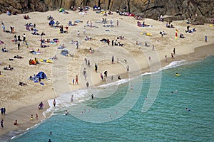 Sunbathers and swimmers on Porthcurno beach