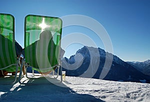 Sunbathers on wintry mountain photo