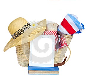 Sunbathing accessories in basket with tablet