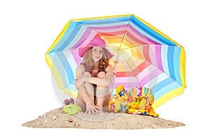 Sunbathing at the beach with colorful parasol