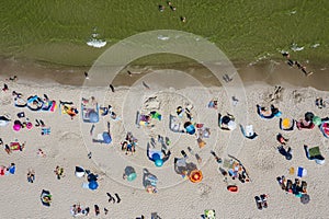 Sunbathing on the beach by the sea. Aerial drone view of  Baltic Sea coast in Hel peninsula, Jastarnia. Puck Bay in Poland