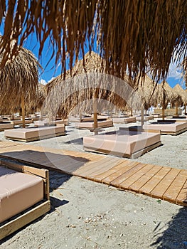 Sunbathing beds and umbrellas on the beach. Navodari Beach, Romania