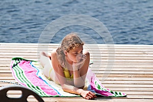 Sunbathing on a lakeside dock