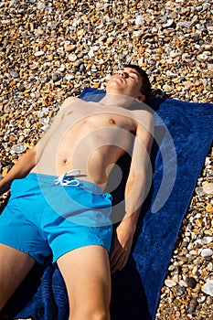 Sunbathing on a stoney beach