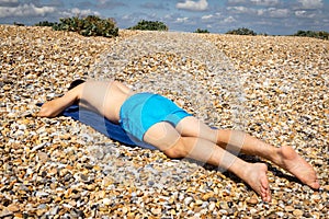 Sunbathing on a stoney beach