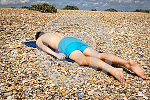 Sunbathing on a stoney beach