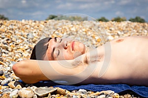 Sunbathing on a stoney beach