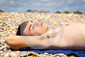 Sunbathing on a stoney beach