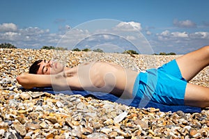 Sunbathing on a stoney beach