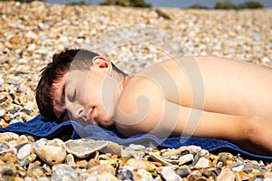 Sunbathing on a stoney beach