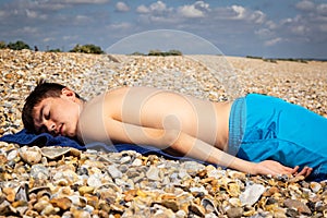 Sunbathing on a stoney beach