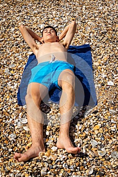 Sunbathing on a stoney beach